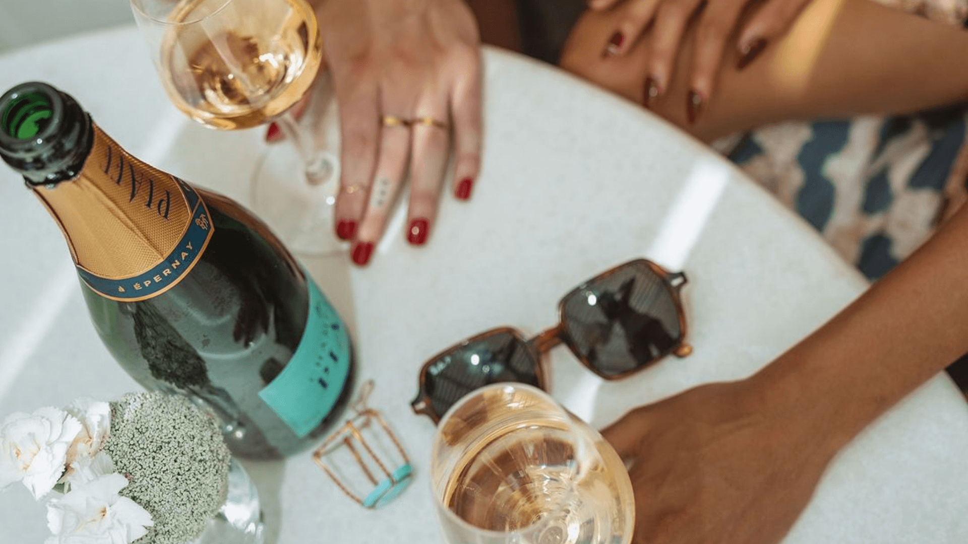 Sparkling wine bottle on a white table.