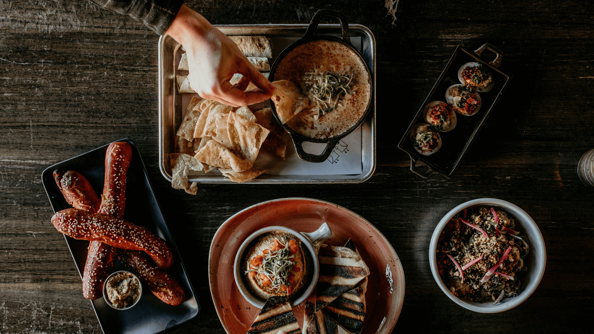 An variety of food on a dark wooden table.