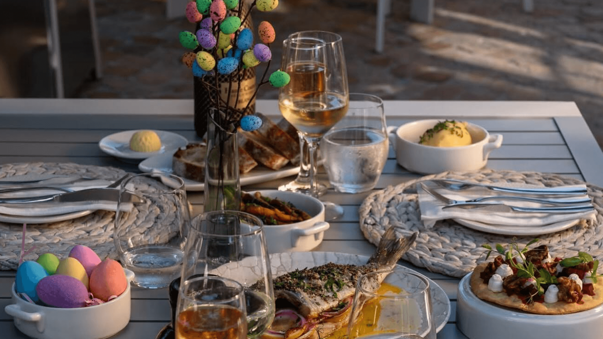 An elegant outdoor dining table set for Easter lunch at Palm House Boutique Hotel and Spa, featuring vibrant spring décor and gourmet dishes.