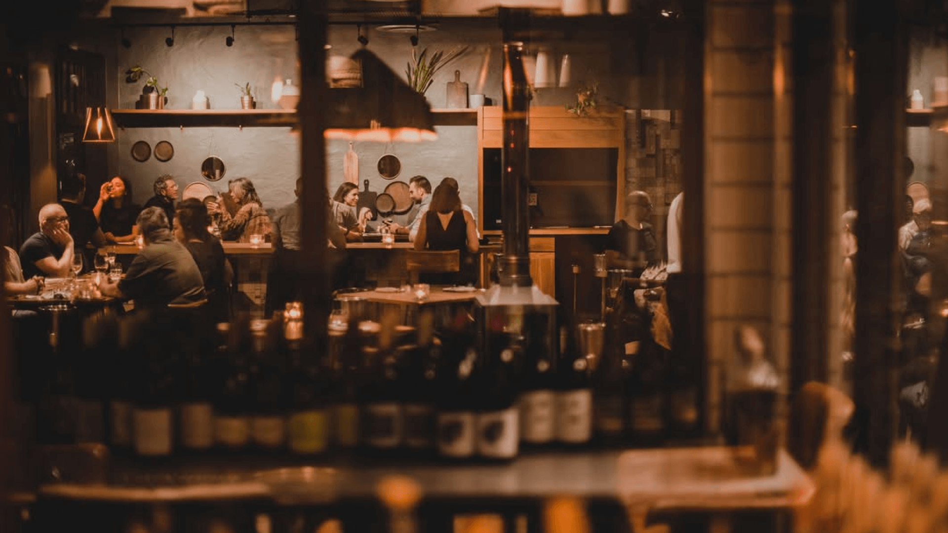 A dark restaurant lit by candlelight.