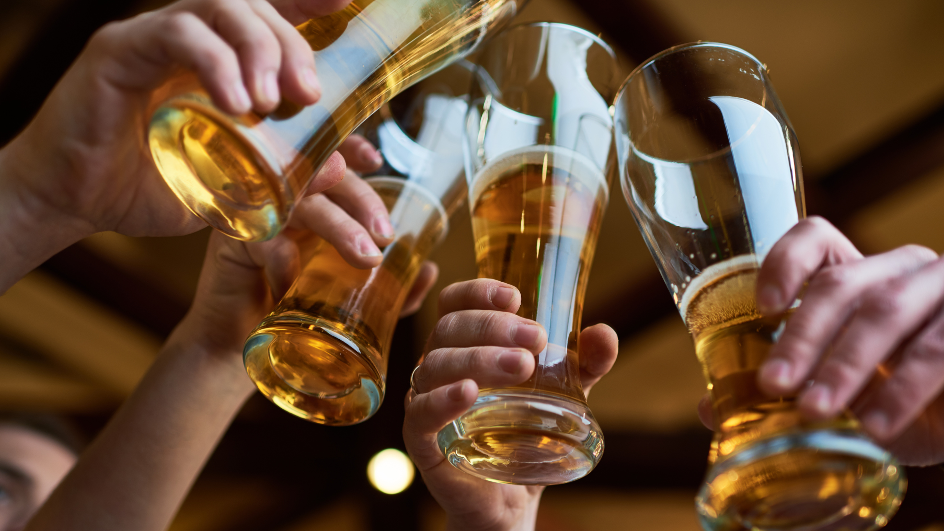 Friends cheers with 4 beer draughts.