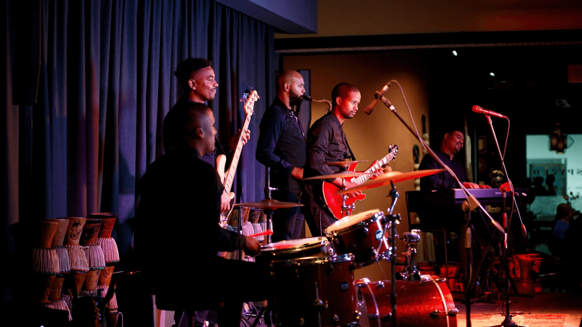 A live jazz band plays on a dimly lit stage.