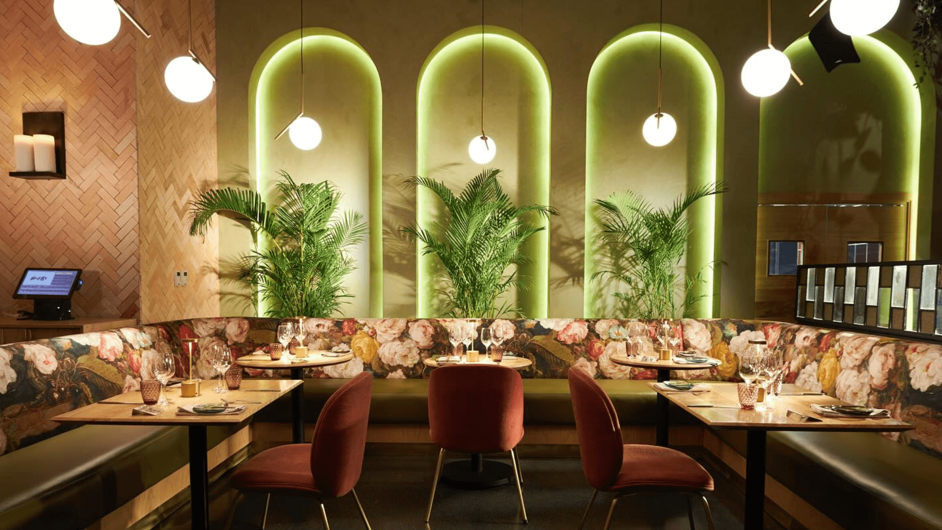 A dining room with three arches lit up in green